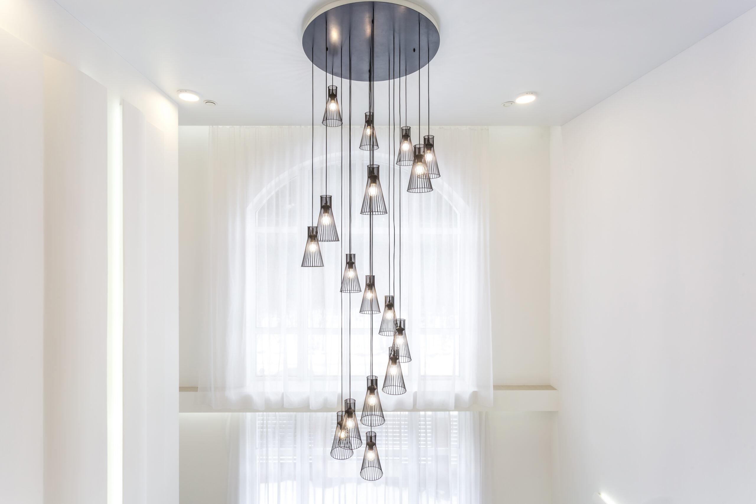 modern chandelier hanging in a bright white room 2026 03 24 07 17 55 utc